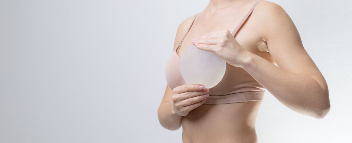 Female caucasian adult holding silicone breast implant