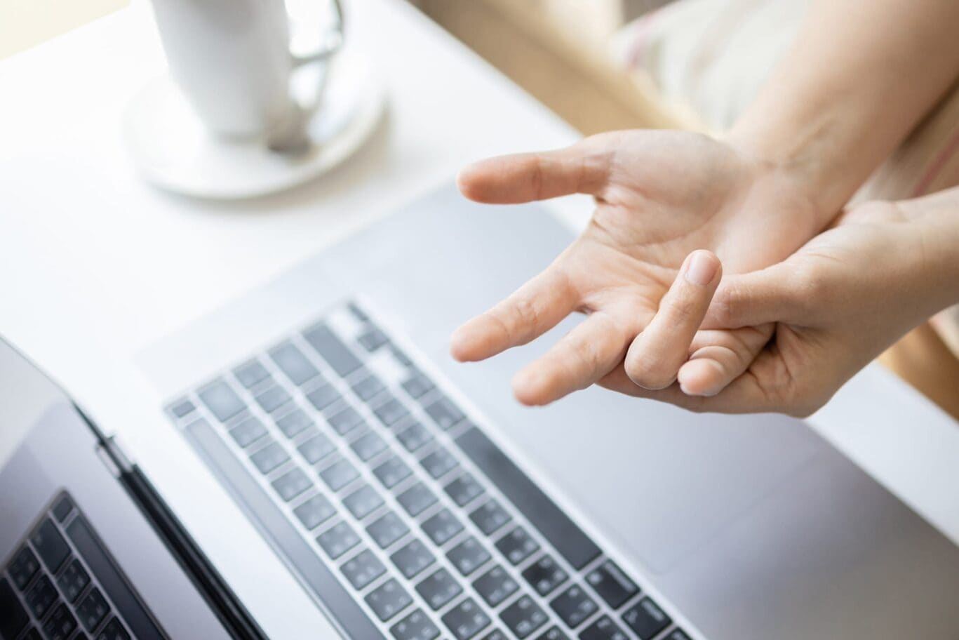 Hand with a bent finger over a computer keyboard